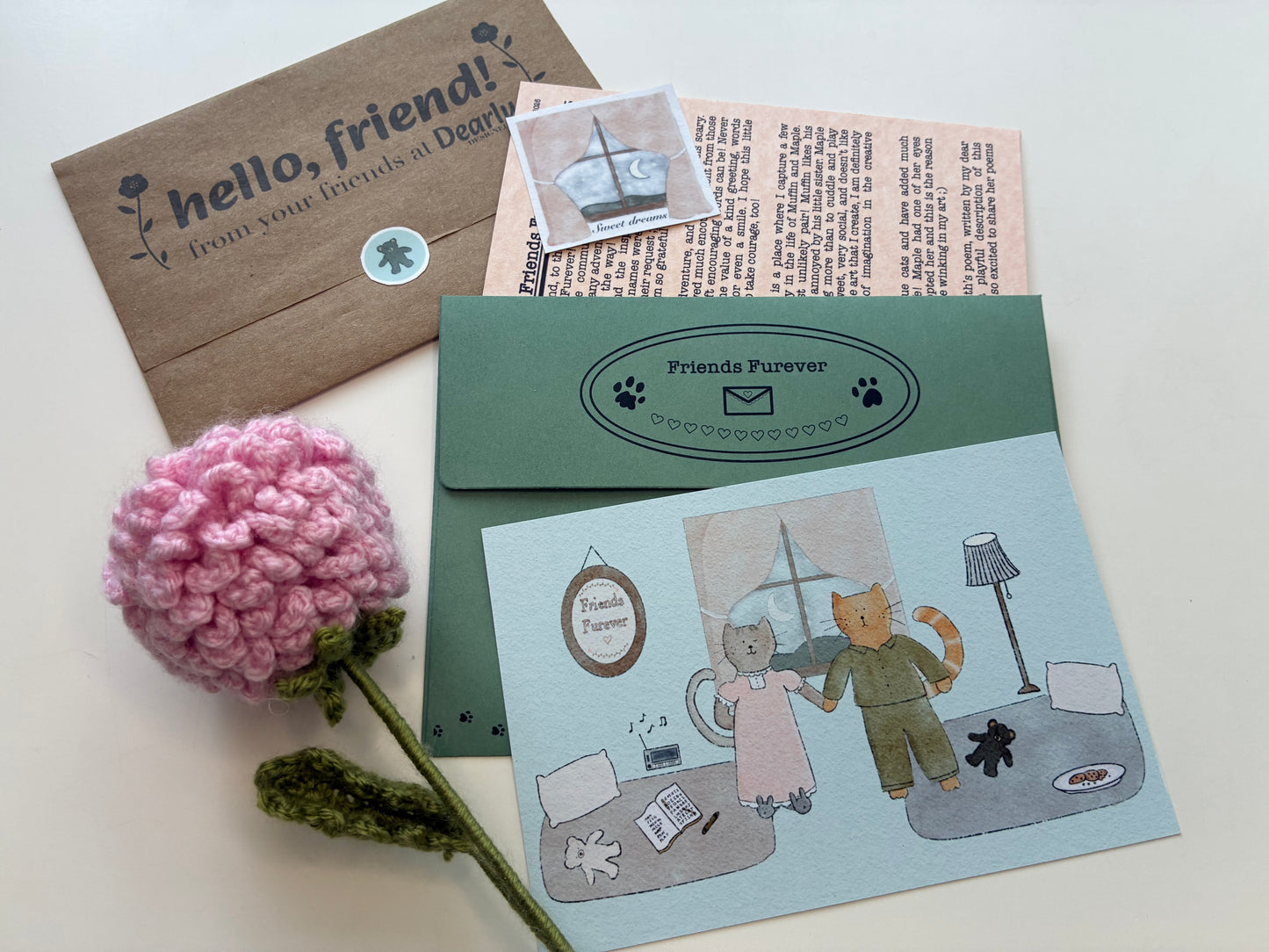 Share the Joy -- Friends Furever Mail Club Duo contents: envelope, custom wrap with mini sticker seal, 4x6 art print postcard, matching vinyl sticker, and illustrated zine with artist letter, Poet's Corner, Kitty Corner, and Fun and Games activity page, signed by the artist and paw-signed by cats Muffin and Maple